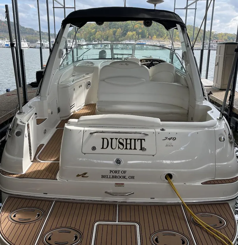Slide: The Image of 2001 Sea Ray 340 Sundancer boat docked, featuring spacious seating and elegant design. - 4