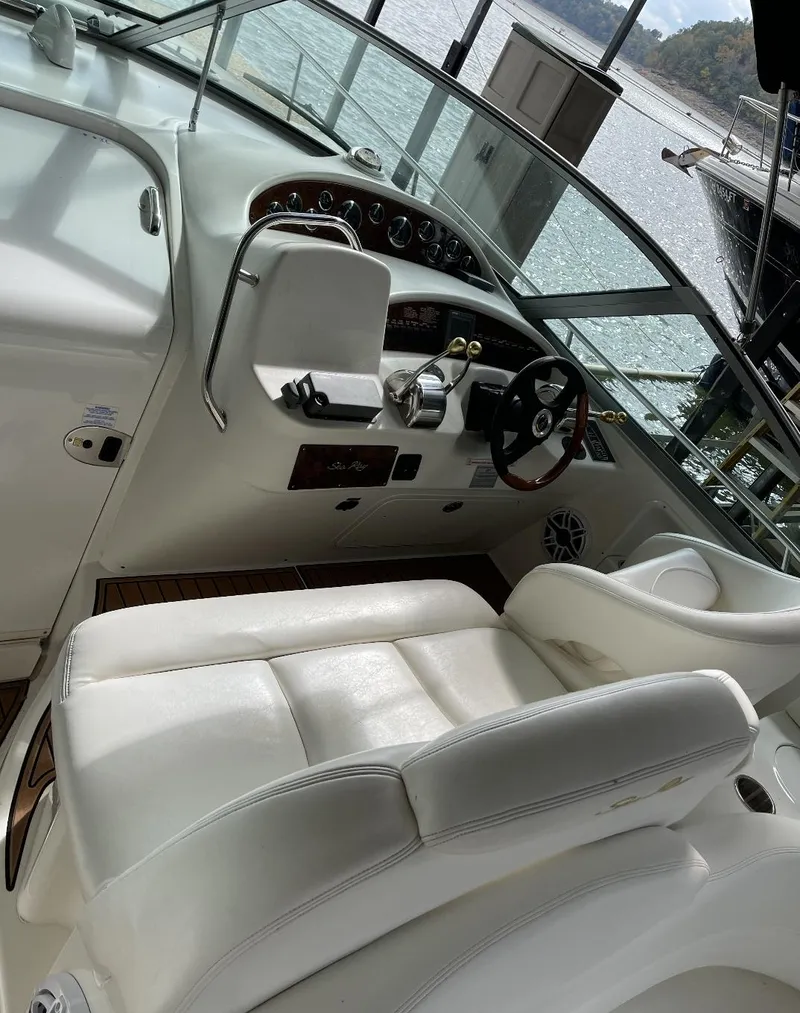 Slide: The Image of 2001 Sea Ray 340 Sundancer cockpit with white leather seats and control panel. - 5