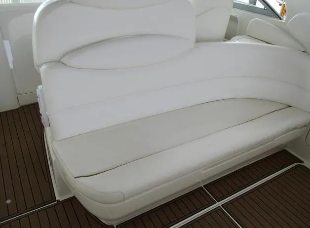 Slide: The Image of White leather seating on 2001 Sea Ray 340 Sundancer boat, with teak flooring. - 8