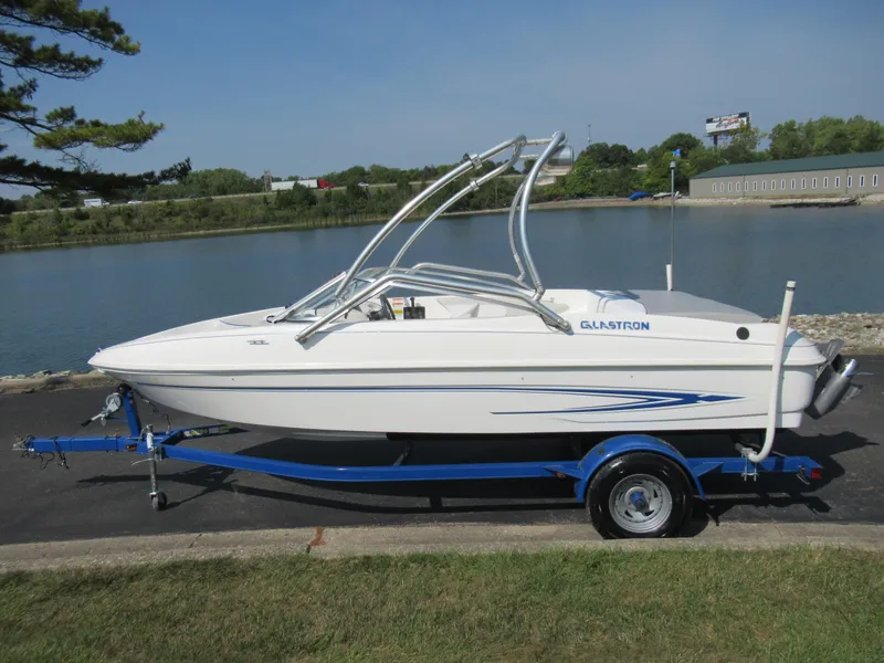 Slide: The Image of 2006 Glastron MX 195 boat on trailer by a lake. - 10