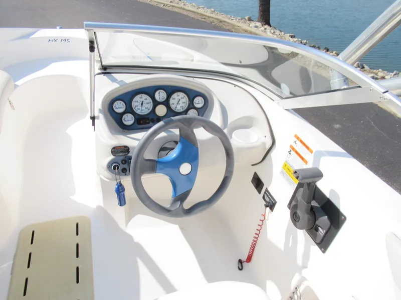 Slide: The Image of 2006 Glastron MX 195 boat dashboard with steering wheel and instrument panel. - 13