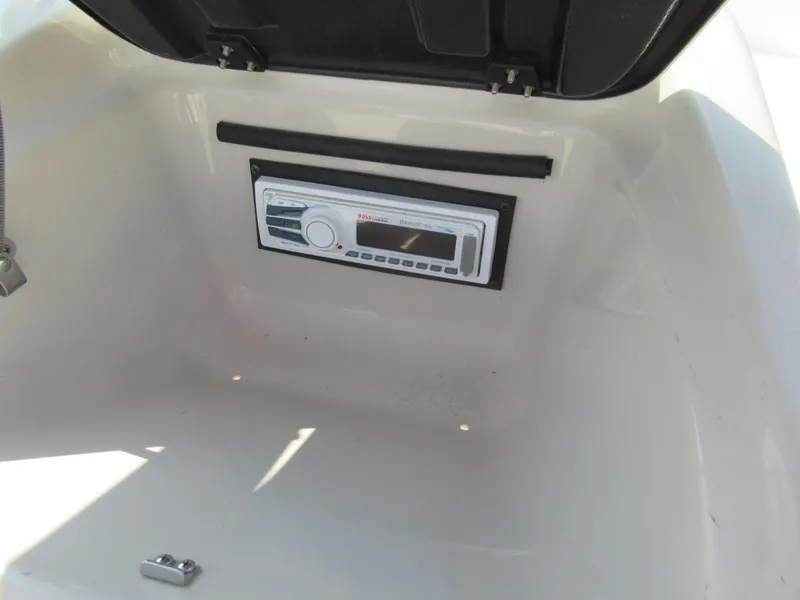 Slide: The Image of 2006 Glastron MX 195 boat interior with built-in stereo system. - 16