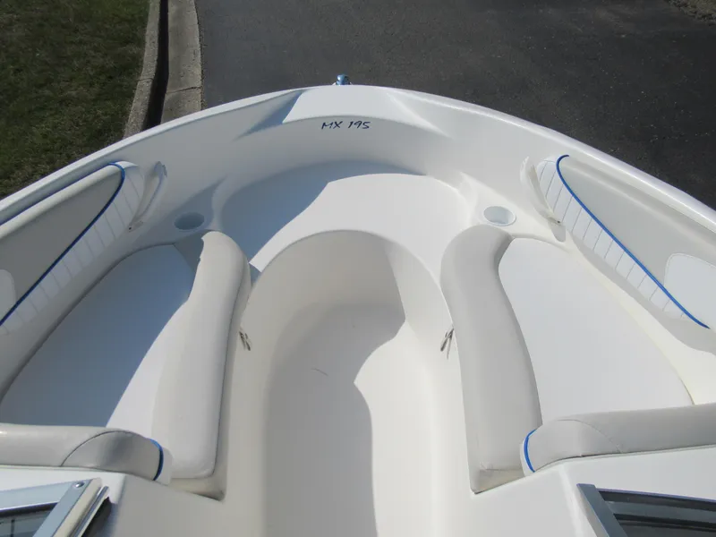 Slide: The Image of 2006 Glastron MX 195 boat interior with white seating and blue accents. - 18