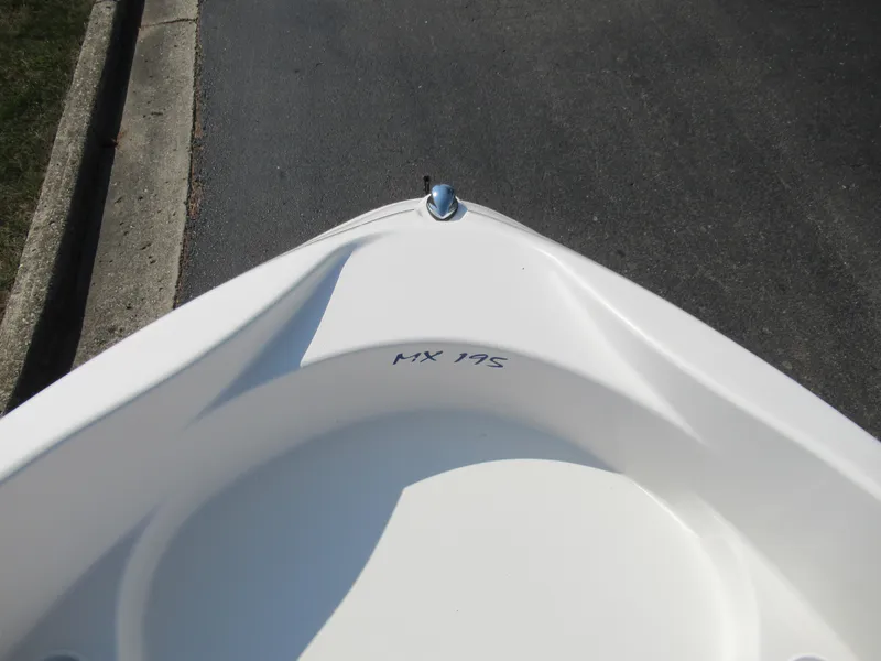 Slide: The Image of 2006 Glastron MX 195 boat bow, white hull, parked on asphalt. - 19