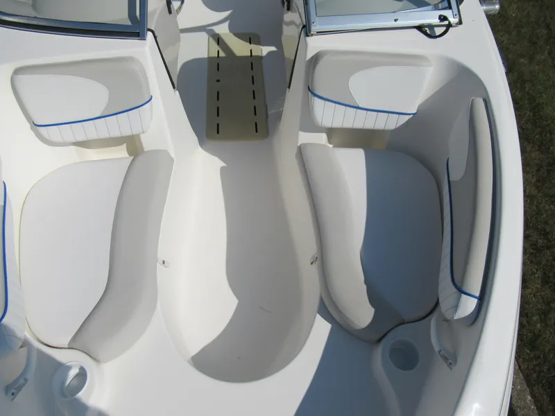 Slide: The Image of 2006 Glastron MX 195 boat interior with white seating and blue accents. - 20