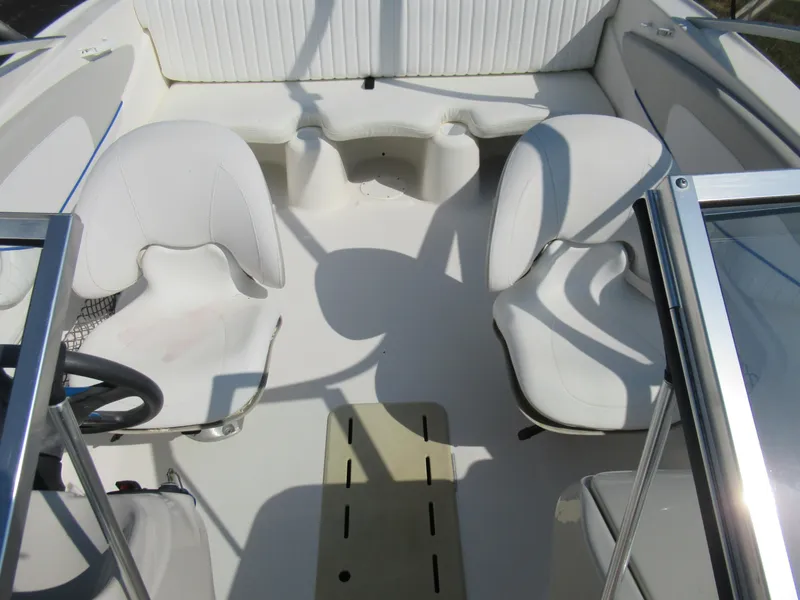 Slide: The Image of 2006 Glastron MX 195 boat interior with white seating and steering wheel. - 22