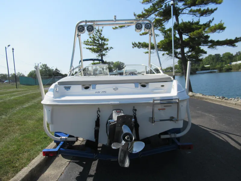 Slide: The Image of 2006 Glastron MX 195 boat on trailer by lakeside, rear view. - 3
