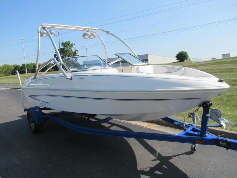 Slide: The Image of 2006 Glastron MX 195 boat on trailer, parked outdoors on a sunny day. - 6