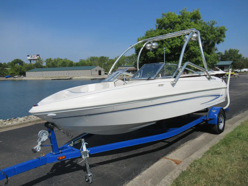 Slide: The Image of 2006 Glastron MX 195 boat on blue trailer by waterfront. - 9