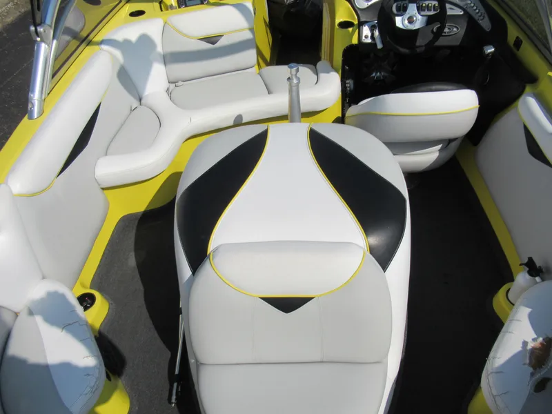 Slide: The Image of 2006 Tigé 22i boat interior with white and black seating, yellow accents. - 11