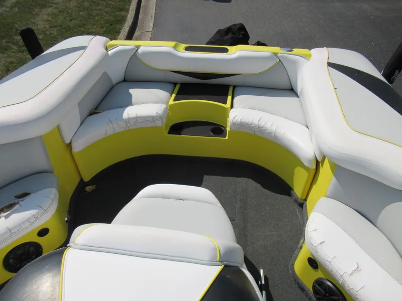 Slide: The Image of 2006 Tigé 22i boat interior with white and yellow seating. - 22