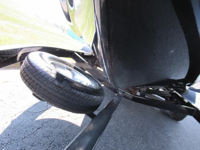 Slide: The Image of 2006 Tigé 22i boat trailer with spare tire on asphalt. - 7