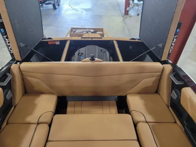 Slide: The Image of 2024 Axis Wake Research A20 boat interior with tan seating and open engine compartment. - 12