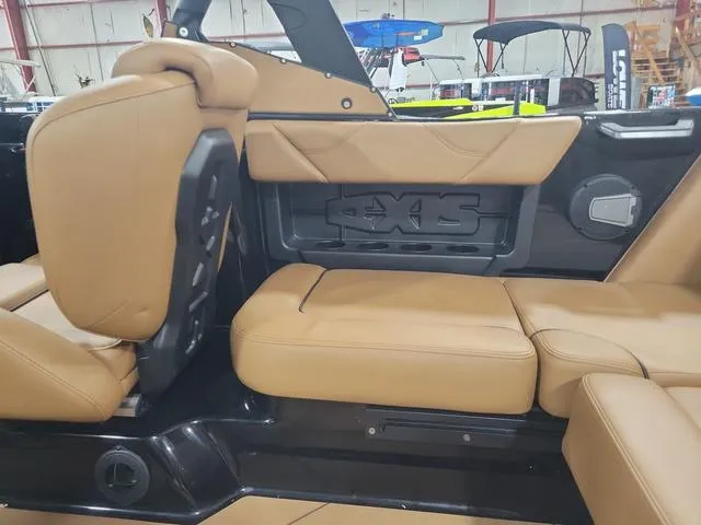Slide: The Image of 2024 Axis Wake Research A20 boat interior with tan leather seats. - 8