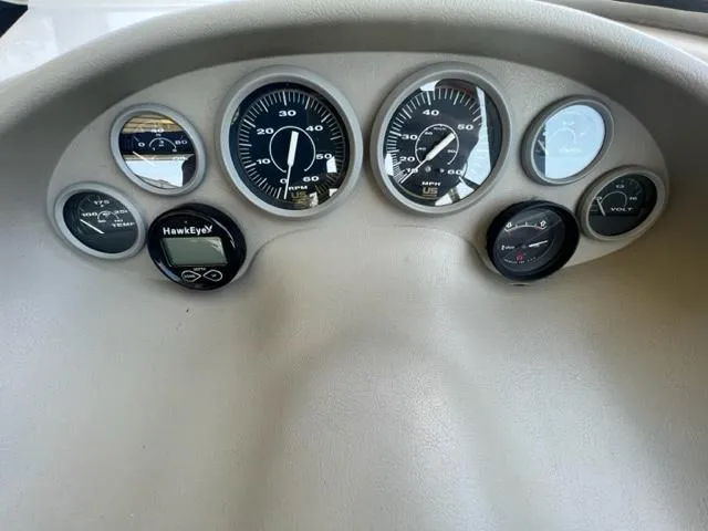 Slide: The Image of Dashboard of a 1995 Bayliner 2050 Capri boat with various gauges and instruments. - 5