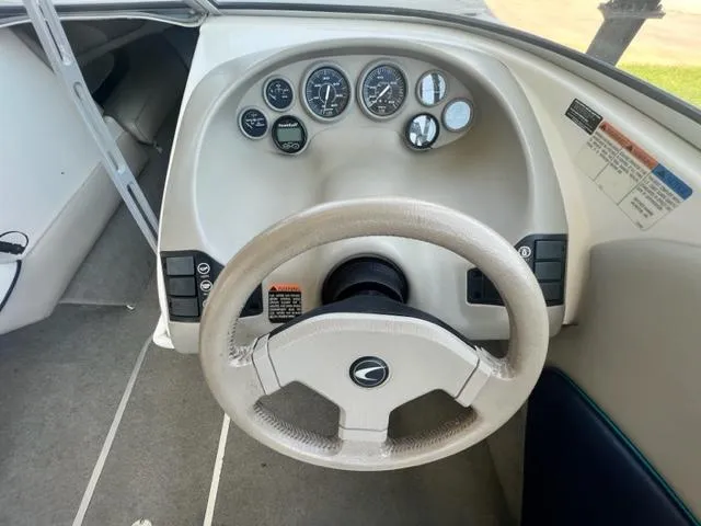 Slide: The Image of 1995 Bayliner 2050 Capri dashboard with steering wheel and instrument panel. - 6