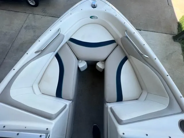 Slide: The Image of 1995 Bayliner 2050 Capri boat interior with white and blue seating. - 8