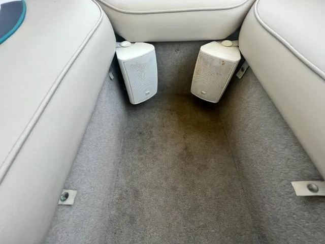 Slide: The Image of Interior of a 1995 Bayliner 2050 Capri boat with speakers and cushioned seating. - 9