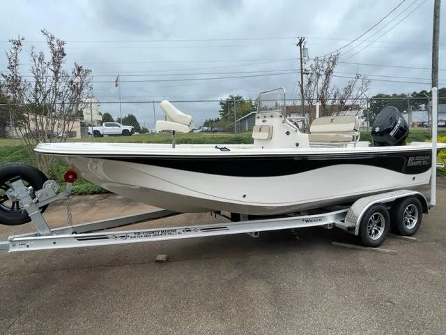 Slide: The Image of 2024 Carolina Skiff 21LS boat on trailer, side view, overcast sky. - 2