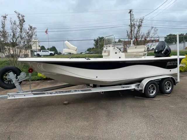 Slide: The Image of 2024 Carolina Skiff 21LS boat on trailer, parked outdoors. - 4