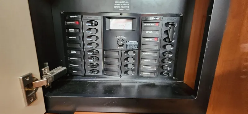 Slide: The Image of Electrical panel of 2006 Maxum 3100 SE boat with labeled switches and controls. - 12