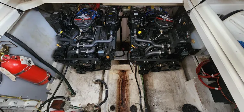 Slide: The Image of Engine compartment of 2006 Maxum 3100 SE boat with dual engines and fire extinguisher. - 3