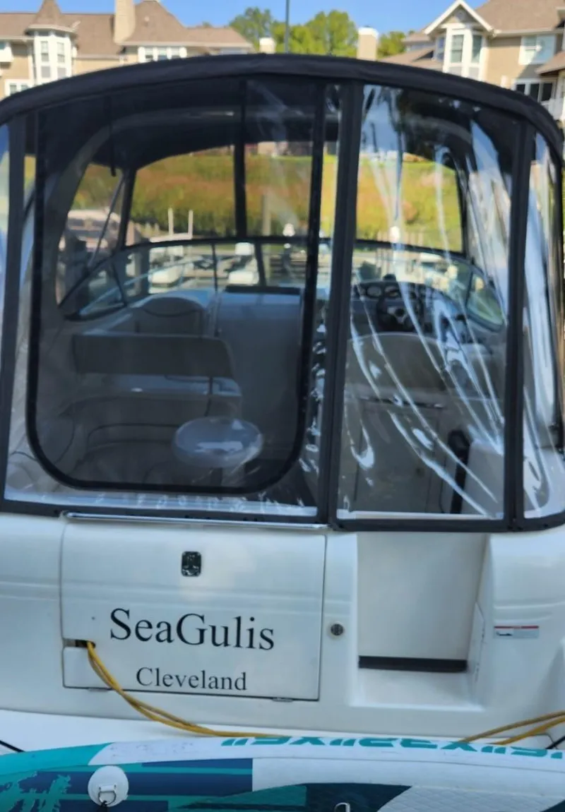 Slide: The Image of 2006 Maxum 3100 SE boat docked, featuring enclosed cockpit and "SeaGulis" name. - 4