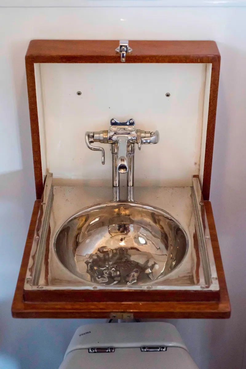 Slide: The Image of Vintage 1947 Trumpy Raised Pilot House sink with wooden frame and chrome faucet. - 12