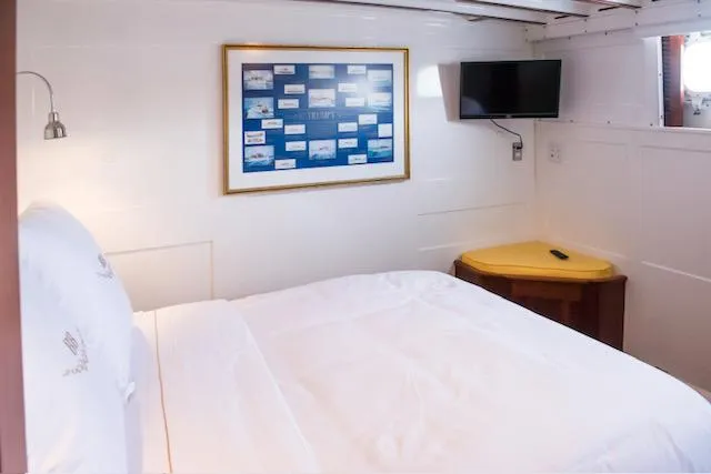 Slide: The Image of Cozy bedroom in a 1947 Trumpy Raised Pilot House yacht with modern amenities. - 14