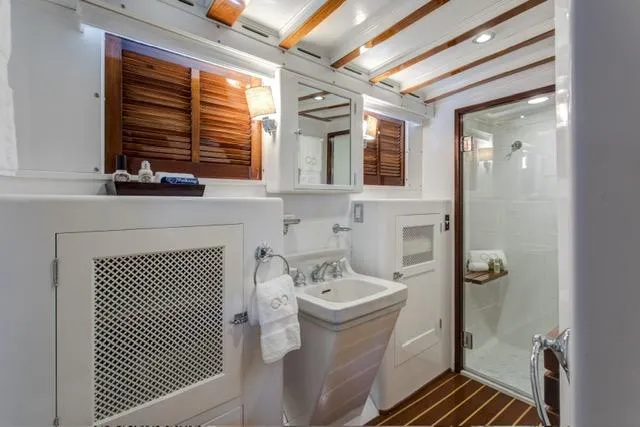 Slide: The Image of Luxurious 1947 Trumpy Raised Pilot House yacht bathroom with wooden accents and modern fixtures. - 15