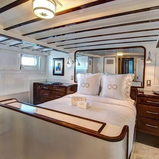 Slide: The Image of Luxurious bedroom in a 1947 Trumpy Raised Pilot House yacht with elegant wooden accents. - 17