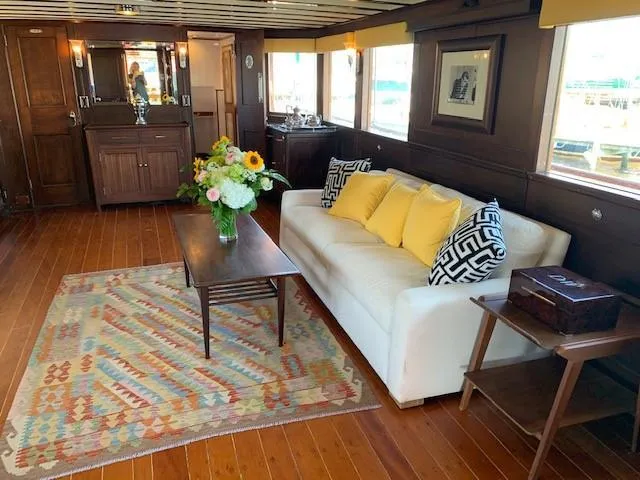 Slide: The Image of Luxurious 1947 Trumpy Raised Pilot House interior with elegant decor and wooden flooring. - 6