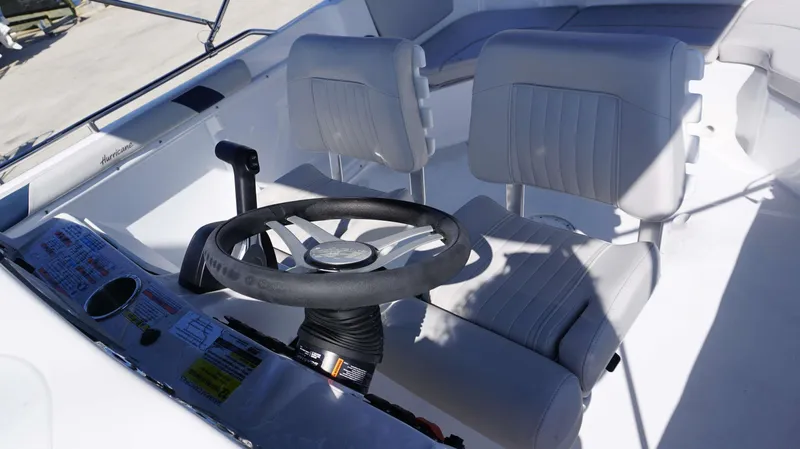 Slide: The Image of 2024 Hurricane 231 SS boat cockpit with steering wheel and dual seats. - 10