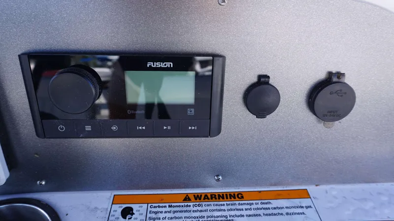 Slide: The Image of 2024 Hurricane 231 SS boat dashboard with Fusion stereo system and USB input. - 11