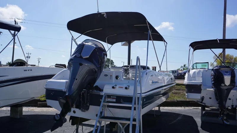 Slide: The Image of 2024 Hurricane 231 SS boat with outboard motor and canopy. - 14