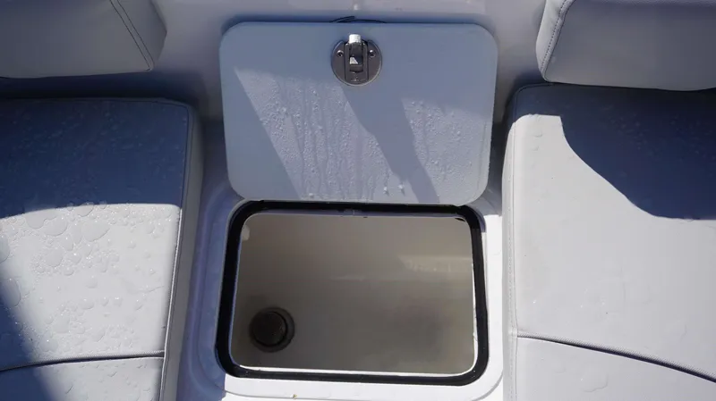 Slide: The Image of 2024 Hurricane 231 SS boat storage compartment with water droplets. - 19