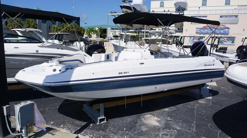 Slide: The Image of 2024 Hurricane 231 SS boat on display at a marina. - 21