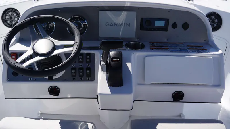 Slide: The Image of 2024 Hurricane 231 SS boat dashboard with Garmin navigation, Yamaha throttle, and control panel. - 8