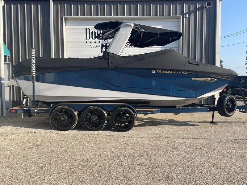 Slide: The Image of 2022 Nautique Super Air Nautique G23 boat on trailer, covered and parked outside. - 12