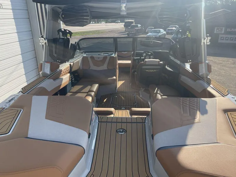 Slide: The Image of 2022 Nautique Super Air Nautique G23 interior with tan and gray seating, luxury design. - 4