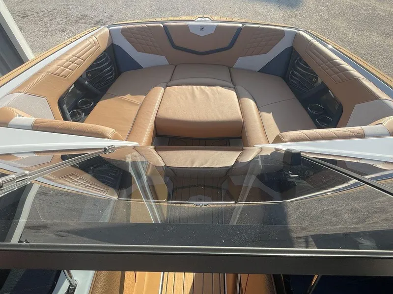 Slide: The Image of 2022 Nautique Super Air Nautique G23 boat interior with tan and white seating. - 6