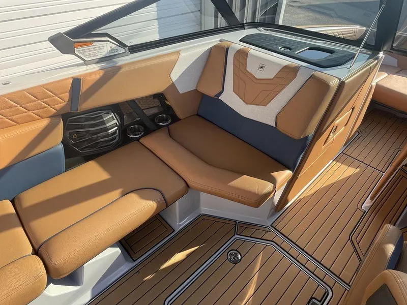 Slide: The Image of 2022 Nautique Super Air Nautique G23 interior with tan leather seating and teak flooring. - 8
