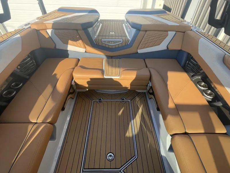 Slide: The Image of Luxurious interior of 2022 Nautique Super Air Nautique G23 boat with tan seating. - 9