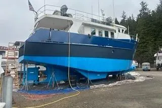 Slide: The Image of 2000 Cape Horn Trawler on dry dock, blue hull, maintenance setting. - 62
