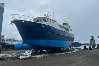 Slide: The Image of Cape Horn Trawler 2000 on dry dock, blue hull, overcast sky. - 64