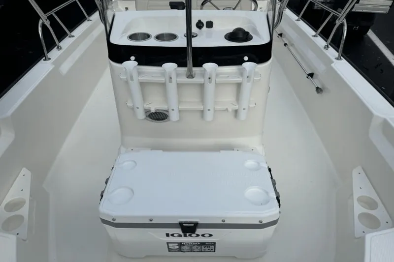 Slide: The Image of 2024 Boston Whaler 170 Montauk boat interior with Igloo cooler and rod holders. - 11