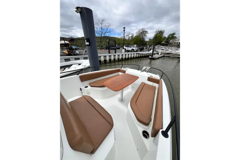 Slide: The Image of 2020 Beneteau Flyer 8 SPACEdeck with brown seating and table, docked at marina. - 12