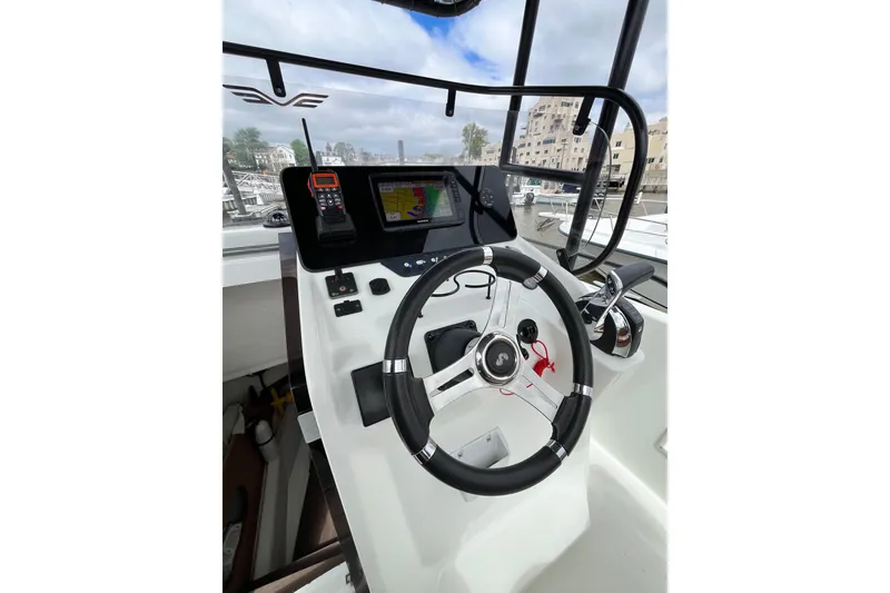 Slide: The Image of Cockpit view of 2020 Beneteau Flyer 8 SPACEdeck with steering wheel and navigation controls. - 18