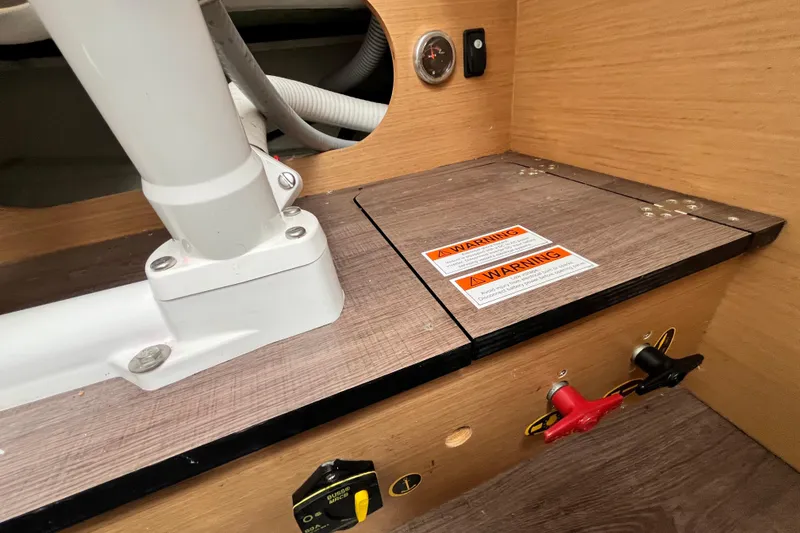 Slide: The Image of Interior view of a 2020 Beneteau Flyer 8 SPACEdeck with warning labels and control valves. - 32