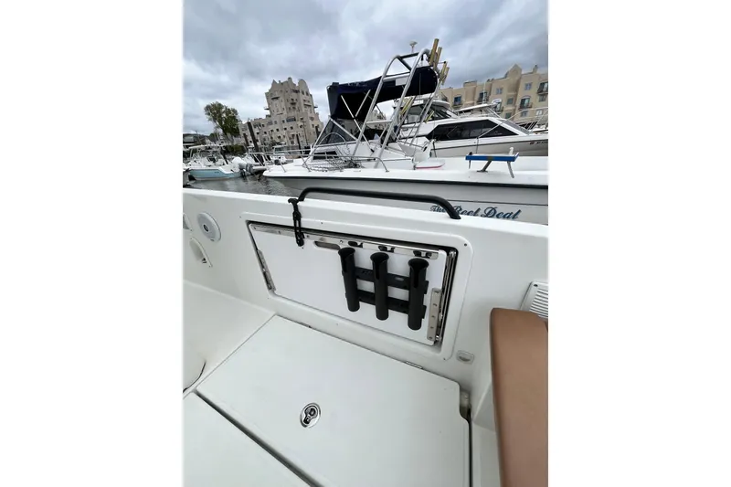 Slide: The Image of 2020 Beneteau Flyer 8 SPACEdeck boat docked, featuring rod holders and storage compartment. - 41